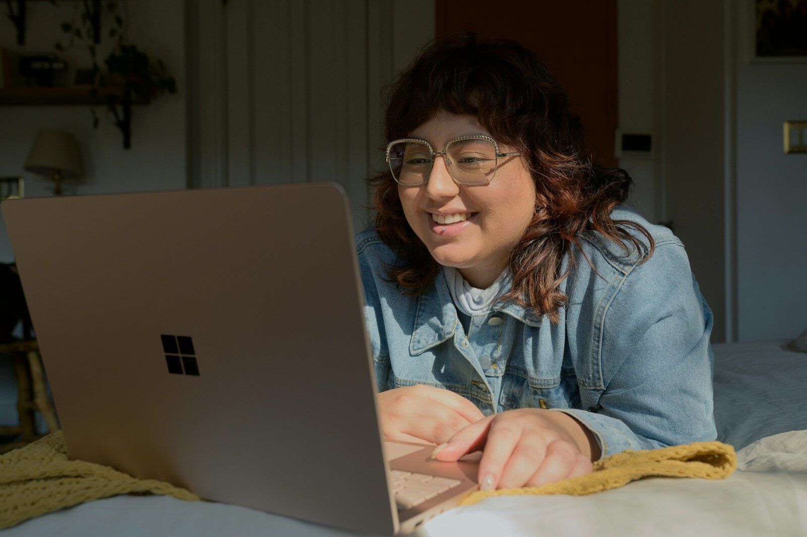 A woman participates in an online mental health therapy session.