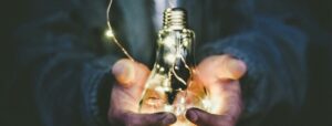 man holding incandescent bulb