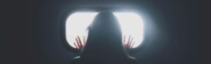 woman stand in front of glass mirror