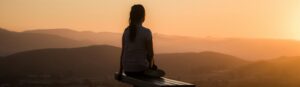 woman sitting on bench over viewing mountain